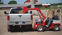 Ventrac KH500 Loader Load mulch and other materials in the bed of a truck.
