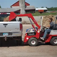 Ventrac KH500 Loader Load mulch and other materials in the bed of a truck.