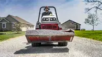 HE482 Power Bucket Spread gravel across long driveways quickly and accurately using the Power Bucket’s 48-inch width and precise hydraulic dump control.