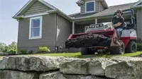HE482 Power Bucket Landscape contractors benefit from mulch work when using the Power Bucket to transport and spread mulch without damaging turf or edging.