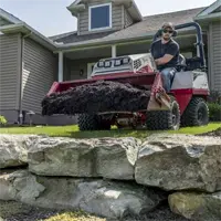 HE482 Power Bucket Landscape contractors benefit from mulch work when using the Power Bucket to transport and spread mulch without damaging turf or edging.