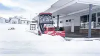 The compact size of the Ventrac tractor, paired with the SE530 V-Blade, makes it possible to clear snow under building overhangs where larger equipment can’t operate—even with the winter cab installed.