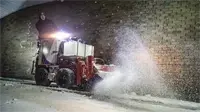 NJ380 Broom In front of a business entrance, the NJ380 Power Broom sweeps away snow and slush cleanly, providing safe, slip-resistant access for customers even after heavy snowfall.